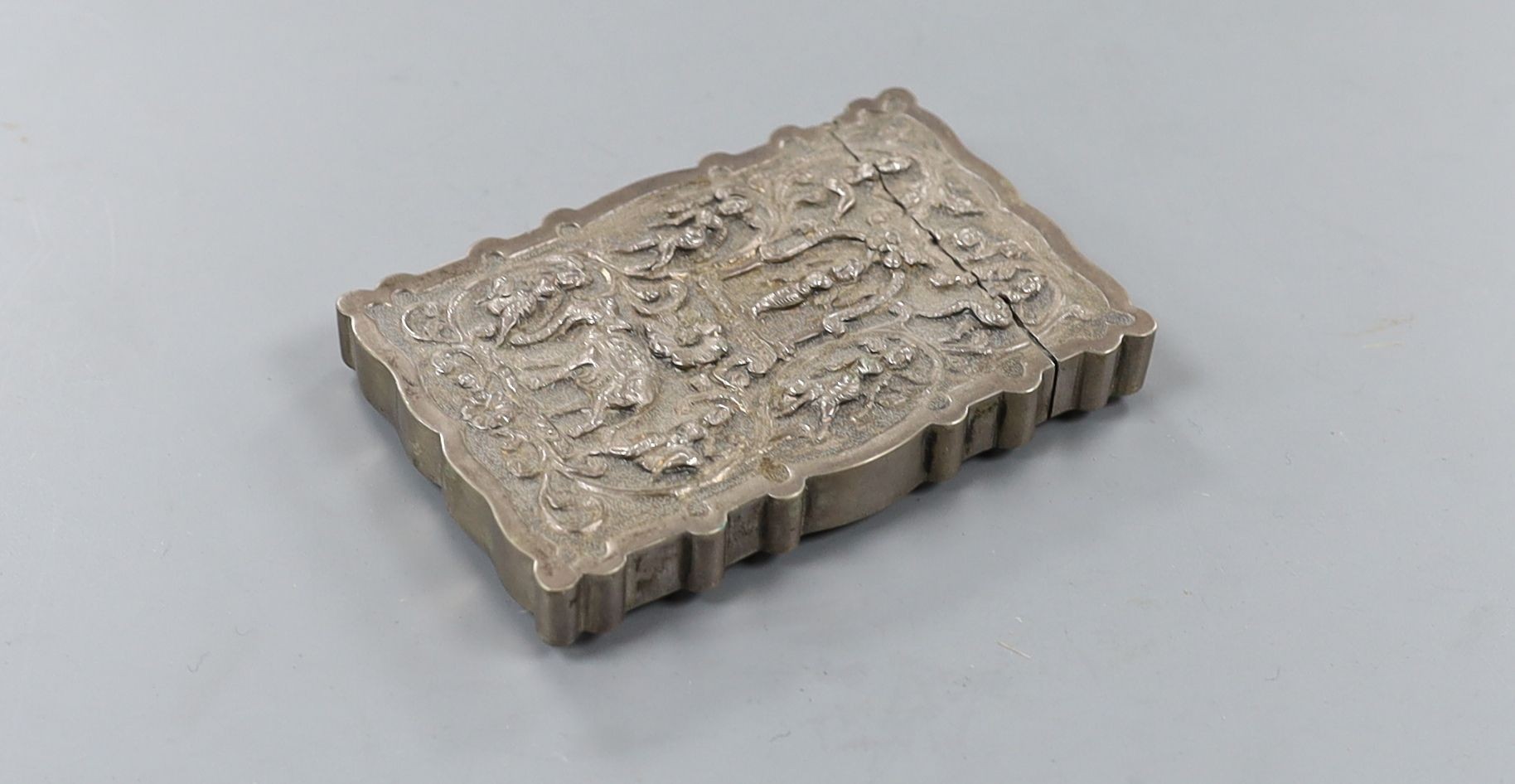 An Indian embossed white metal card case, decorated with figures and elephants, 97mm